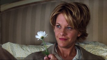 Movie still from “You've Got Mail” (1998), directed by Nora Ephron – A person holding a flower; Close Up shot, Over the shoulder angle