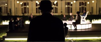 Movie still from “Youth” (2015), directed by Paolo Sorrentino – A man wearing a black hat and a black jacket; Medium shot, Over the shoulder angle
