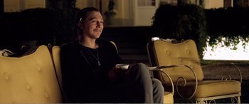 Movie still from “Youth” (2015), directed by Paolo Sorrentino – A man sitting on a chair holding a coffee cup; Medium shot, Over the shoulder angle