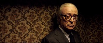 Movie still from “Youth” (2015), directed by Paolo Sorrentino – An older man wearing a suit and tie; Close Up shot, Low angle