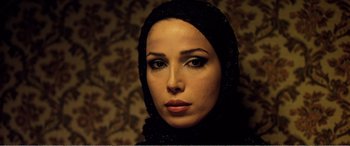 Movie still from “Youth” (2015), directed by Paolo Sorrentino – A person wearing a headscarf; Close Up shot, Over the shoulder angle