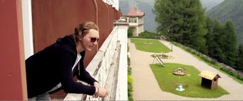 Movie still from “Youth” (2015), directed by Paolo Sorrentino – A man leaning on a wall looking over a fence; Medium shot, High angle