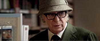 Movie still from “Youth” (2015), directed by Paolo Sorrentino – An older man wearing a hat and glasses; Close Up shot, Over the shoulder angle