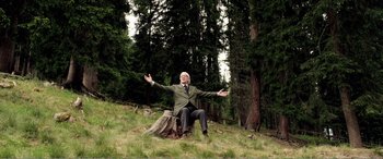 Movie still from “Youth” (2015), directed by Paolo Sorrentino – An older man sitting on a stump in the middle of a forest; Wide shot, Low angle