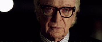 Movie still from “Youth” (2015), directed by Paolo Sorrentino – An older man wearing glasses looking at the camera; Close Up shot, Over the shoulder angle