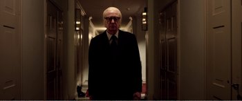 Movie still from “Youth” (2015), directed by Paolo Sorrentino – An older man in a suit and tie standing in a hallway; Medium shot, Low angle