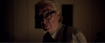 Movie still from “Youth” (2015), directed by Paolo Sorrentino – An older man wearing glasses and a striped shirt; Close Up shot, Low angle