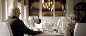 Movie still from “Youth” (2015), directed by Paolo Sorrentino – People are sitting at a table in a restaurant; Medium shot, Over the shoulder angle