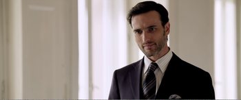 Movie still from “Youth” (2015), directed by Paolo Sorrentino – A person wearing a suit and tie; Close Up shot, Over the shoulder angle