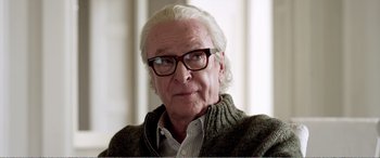 Movie still from “Youth” (2015), directed by Paolo Sorrentino – An older man wearing glasses and wearing a sweater; Close Up shot, Over the shoulder angle