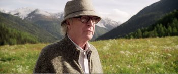 Movie still from “Youth” (2015), directed by Paolo Sorrentino – An older man wearing a hat in a grassy field; Close Up shot, Low angle