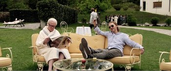 Movie still from “Youth” (2015), directed by Paolo Sorrentino – A man sitting on a couch next to an older woman; Medium shot, Low angle