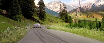 Movie still from “Youth” (2015), directed by Paolo Sorrentino – A car driving down a curvy road in the mountains; Extreme Wide shot, High angle