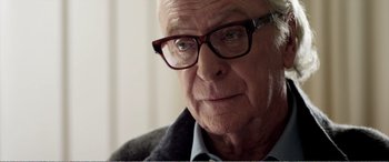 Movie still from “Youth” (2015), directed by Paolo Sorrentino – An older man wearing glasses looking at the camera; Close Up shot, Over the shoulder angle