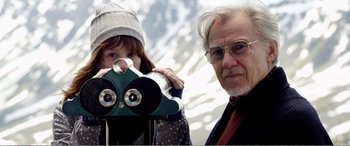 Movie still from “Youth” (2015), directed by Paolo Sorrentino – An older man and a young girl looking through a telescope; Medium shot, Low angle