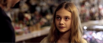Movie still from “Youth” (2015), directed by Paolo Sorrentino – A young girl with long blonde hair looking at the camera; Close Up shot, Over the shoulder angle