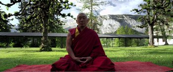 Movie still from “Youth” (2015), directed by Paolo Sorrentino – A man in a red robe sitting on the ground; Medium shot, High angle