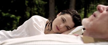 Movie still from “Youth” (2015), directed by Paolo Sorrentino – A woman laying on the ground with her head resting on a pillow; Close Up shot, High angle