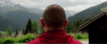 Movie still from “Youth” (2015), directed by Paolo Sorrentino – A man in a red shirt is looking out at the mountains; Close Up shot, Low angle