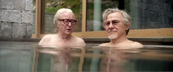 Movie still from “Youth” (2015), directed by Paolo Sorrentino – Two older men are swimming in a pool; Medium shot, High angle