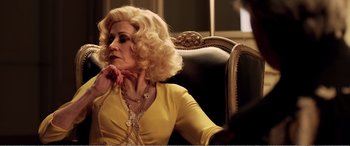 Movie still from “Youth” (2015), directed by Paolo Sorrentino – An older woman sitting in a chair wearing a yellow dress; Close Up shot, Over the shoulder angle