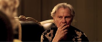 Movie still from “Youth” (2015), directed by Paolo Sorrentino – An older man sitting in a chair with his hand to his mouth; Close Up shot, Over the shoulder angle