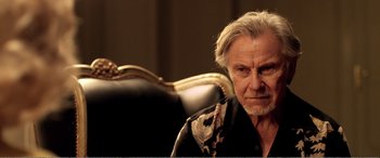 Movie still from “Youth” (2015), directed by Paolo Sorrentino – An older man sitting in a chair looking at the camera; Close Up shot, Over the shoulder angle