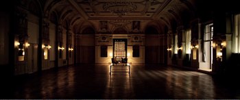 Movie still from “Youth” (2015), directed by Paolo Sorrentino – Two people sitting in a dark room with lights on; Extreme Wide shot, High angle