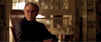Movie still from “Youth” (2015), directed by Paolo Sorrentino – An older man sitting in a chair in a room; Close Up shot, Over the shoulder angle