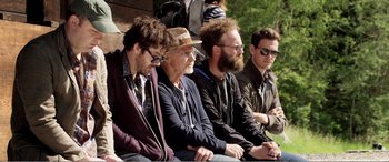Movie still from “Youth” (2015), directed by Paolo Sorrentino – A group of men sitting next to each other on a bench; Medium shot, Over the shoulder angle