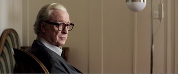 Movie still from “Youth” (2015), directed by Paolo Sorrentino – An older man wearing glasses looking off to his right; Close Up shot, Over the shoulder angle