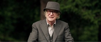 Movie still from “Youth” (2015), directed by Paolo Sorrentino – An older man wearing a hat and glasses; Close Up shot, Over the shoulder angle