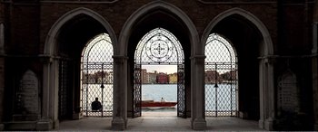 Movie still from “Youth” (2015), directed by Paolo Sorrentino – A view of a lake through a window with a boat on it; Extreme Wide shot, High angle