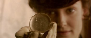 Movie still from “Youth Without Youth” (2007), directed by Francis Ford Coppola – A person holding an object in their hand; Extreme Close Up shot, Overhead angle