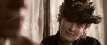 Movie still from “Youth Without Youth” (2007), directed by Francis Ford Coppola – A young woman wearing a hat and a black jacket; Close Up shot, Over the shoulder angle