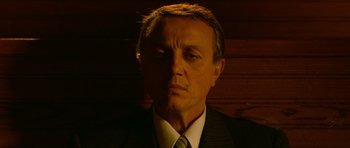 Movie still from “Youth Without Youth” (2007), directed by Francis Ford Coppola – A person wearing a suit and tie; Close Up shot, Low angle