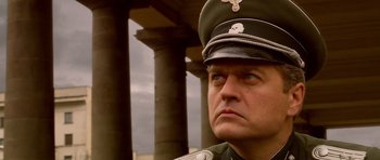 Movie still from “Youth Without Youth” (2007), directed by Francis Ford Coppola – A person wearing a uniform; Close Up shot, Low angle
