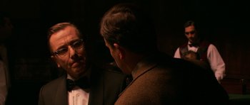 Movie still from “Youth Without Youth” (2007), directed by Francis Ford Coppola – Two men in suits talking to each other in a dark room; Close Up shot, Over the shoulder angle