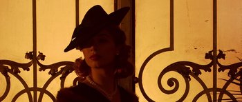 Movie still from “Youth Without Youth” (2007), directed by Francis Ford Coppola – A woman with a hat and a necklace; Close Up shot, Low angle