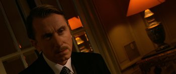 Movie still from “Youth Without Youth” (2007), directed by Francis Ford Coppola – A person wearing a suit and tie; Close Up shot, Over the shoulder angle