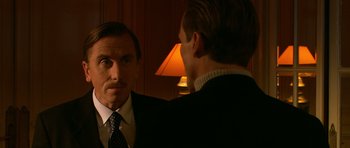 Movie still from “Youth Without Youth” (2007), directed by Francis Ford Coppola – A man in a suit and tie standing next to another man in a suit and tie; Close Up shot, Over the shoulder angle