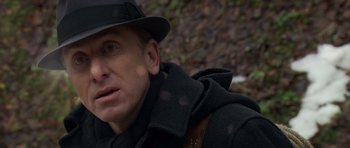 Movie still from “Youth Without Youth” (2007), directed by Francis Ford Coppola – A person wearing a hat and a jacket; Close Up shot, Over the shoulder angle