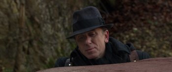 Movie still from “Youth Without Youth” (2007), directed by Francis Ford Coppola – A man in a hat is sitting on a park bench; Close Up shot, Low angle
