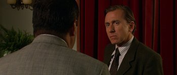 Movie still from “Youth Without Youth” (2007), directed by Francis Ford Coppola – A man wearing a suit and tie looking at himself in the mirror; Close Up shot, Over the shoulder angle
