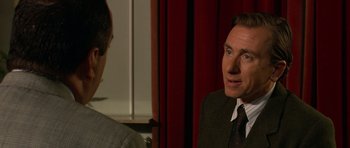 Movie still from “Youth Without Youth” (2007), directed by Francis Ford Coppola – A man wearing a suit and tie talking to another man in a suit; Close Up shot, Over the shoulder angle