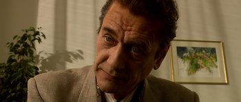 Movie still from “Youth Without Youth” (2007), directed by Francis Ford Coppola – An older man wearing a suit and tie looking at the camera; Close Up shot, Low angle