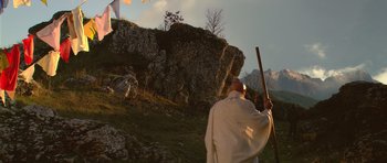 Movie still from “Youth Without Youth” (2007), directed by Francis Ford Coppola – A man holding a stick on top of a hill; Wide shot, Low angle