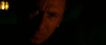 Movie still from “Youth Without Youth” (2007), directed by Francis Ford Coppola – A person's face with a dark background; Extreme Close Up shot, Low angle