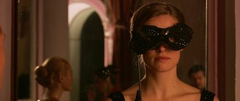 Movie still from “Youth Without Youth” (2007), directed by Francis Ford Coppola – A woman wearing a black mask and a black dress; Close Up shot, Over the shoulder angle