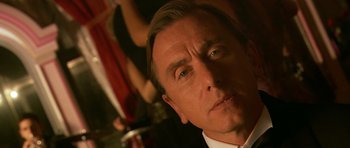 Movie still from “Youth Without Youth” (2007), directed by Francis Ford Coppola – A man's face in front of a crowd; Close Up shot, Low angle